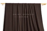 DM09-014 — Recycled Nylon Cotton-Feel Rib Fabric — hanging fabric on wooden bar