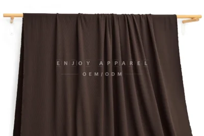 DM09-014 — Recycled Nylon Cotton-Feel Rib Fabric — hanging fabric on wooden bar