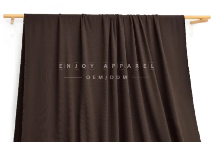 DM09-014 — Recycled Nylon Cotton-Feel Rib Fabric — hanging fabric on wooden bar
