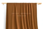 JL02-060 — Matte Nylon Spandex Swim Fabric — hanging fabric on wooden bar