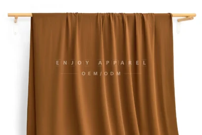 JL02-060 — Matte Nylon Spandex Swim Fabric — hanging fabric on wooden bar