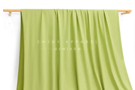 JL12-036 — Matte Single Jersey Nylon Spandex Fabric — hanging fabric on wooden bar