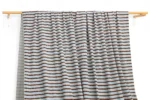 DM0007 — Cotton Spandex Waffle Fabric — hanging fabric on wooden bar