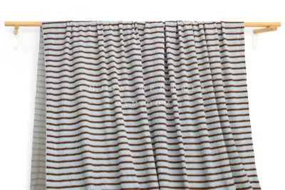 DM0007 — Cotton Spandex Waffle Fabric — hanging fabric on wooden bar