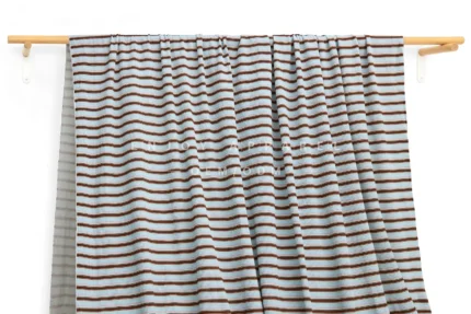DM0007 — Cotton Spandex Waffle Fabric — hanging fabric on wooden bar