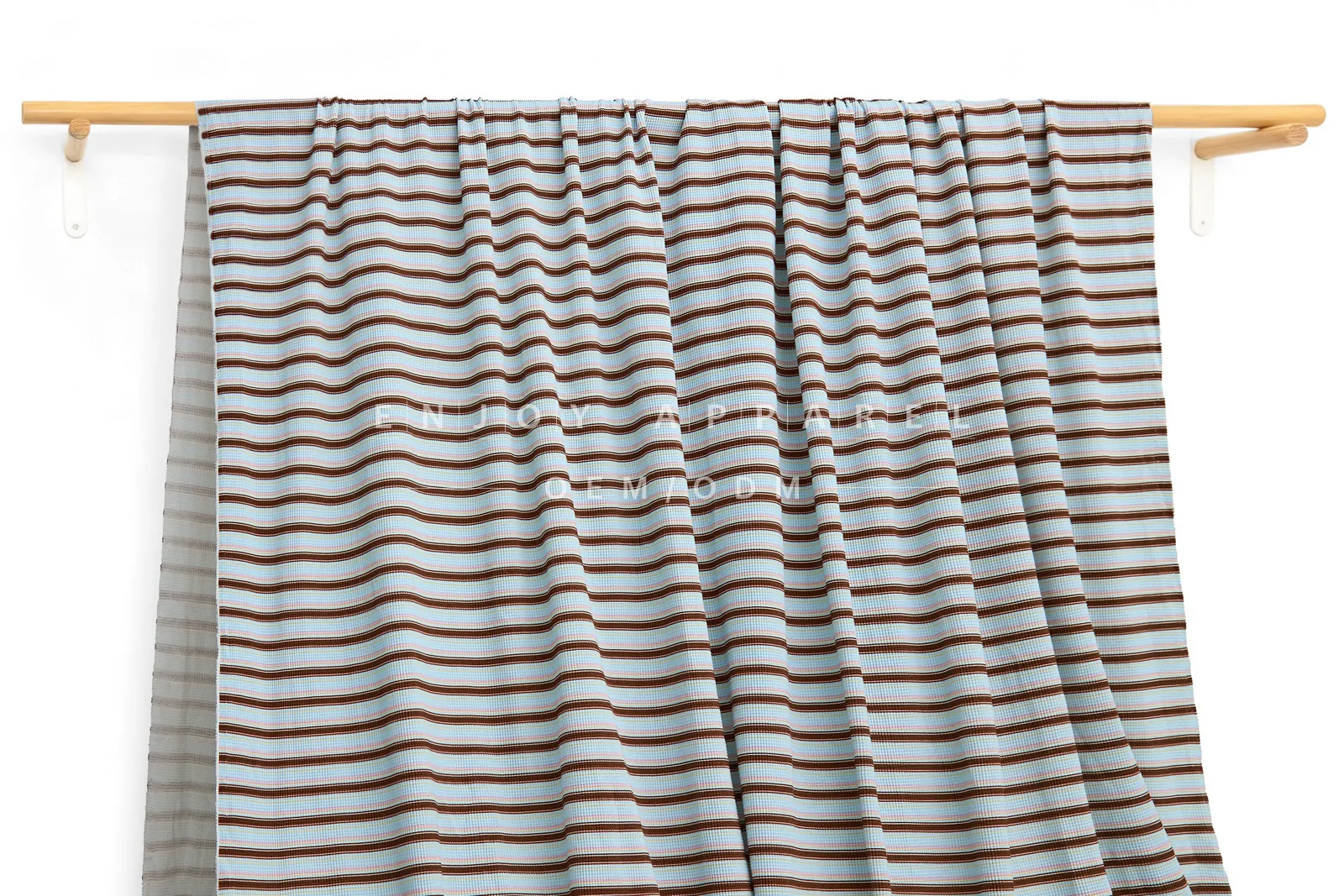 DM0007 — Cotton Spandex Waffle Fabric — hanging fabric on wooden bar