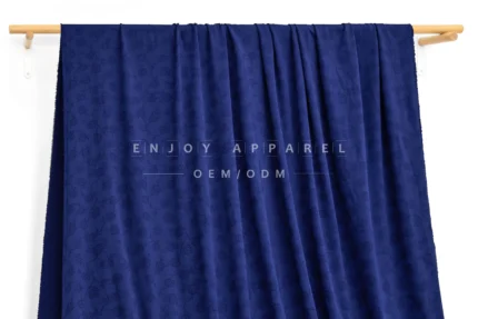 JL04-001 — Rose Jacquard Nylon Spandex Fabric — hanging fabric on wooden bar