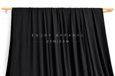 JL0079 — Nylon Spandex Swim Fabric — hanging fabric on wooden bar