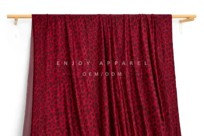 JL01-039-LEO — Leopard Print Warp Knit Fabric — hanging fabric on wooden bar