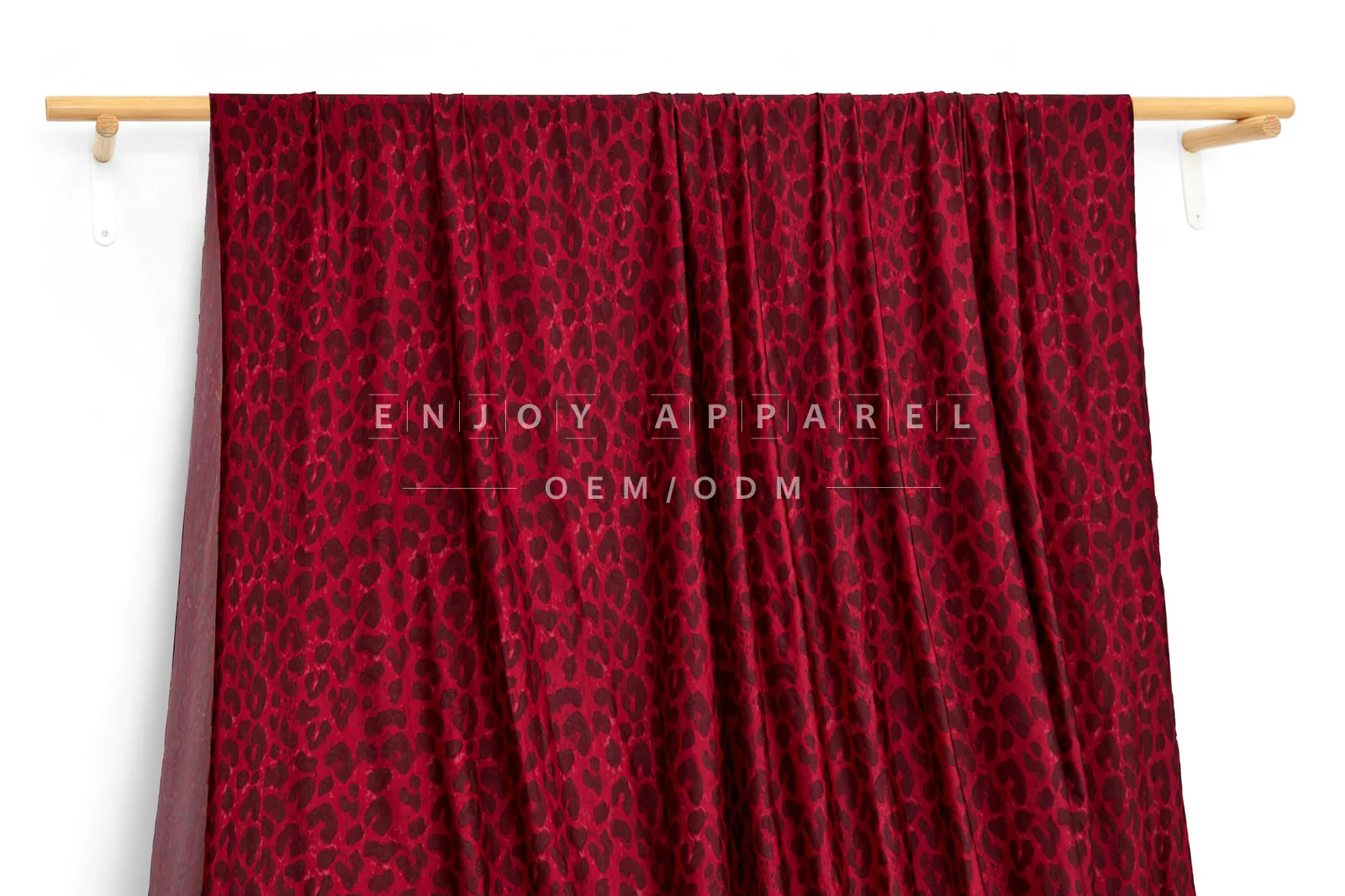 JL01-039-LEO — Leopard Print Warp Knit Fabric — hanging fabric on wooden bar