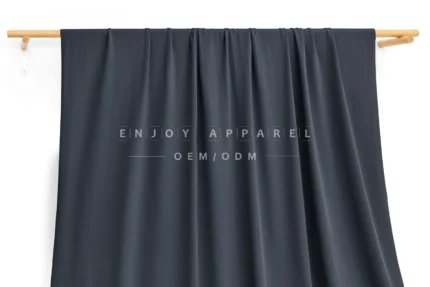 JL0085 — 36-Gauge Matte Warp Knit Nylon Fabric — hanging fabric on wooden bar