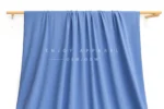 JL02-239 — Matte Warp Knit Nylon Spandex Fabric — hanging fabric on wooden bar