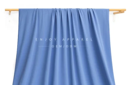 JL02-239 — Matte Warp Knit Nylon Spandex Fabric — hanging fabric on wooden bar