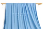 JL0086 — Matte Weft Knit Nylon Spandex Fabric — hanging fabric on wooden bar