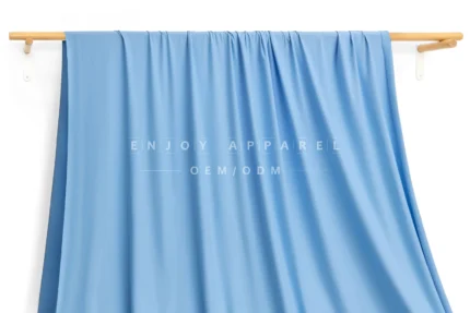 JL0086 — Matte Weft Knit Nylon Spandex Fabric — hanging fabric on wooden bar