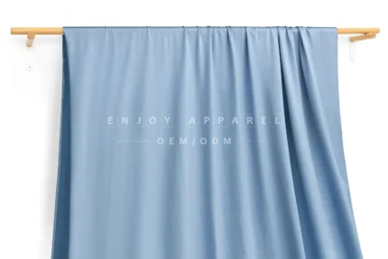 JL0088 — Lustrous Warp Knit Nylon Swim Fabric — hanging fabric on wooden bar