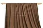 DL0053 — Weft Knit Faux Suede Fabric — hanging fabric on wooden bar